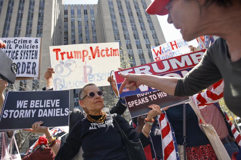 A protestor demonstrates against Donald Trump amidst Trump supporters outside Manhattan criminal court, Monday, April 15, 2024, in New York. The hush money trial of former President Donald Trump begins Monday with jury selection. It's a singular moment for American history as the first criminal trial of a former U.S. commander in chief. (AP Photo/Stefan Jeremiah)