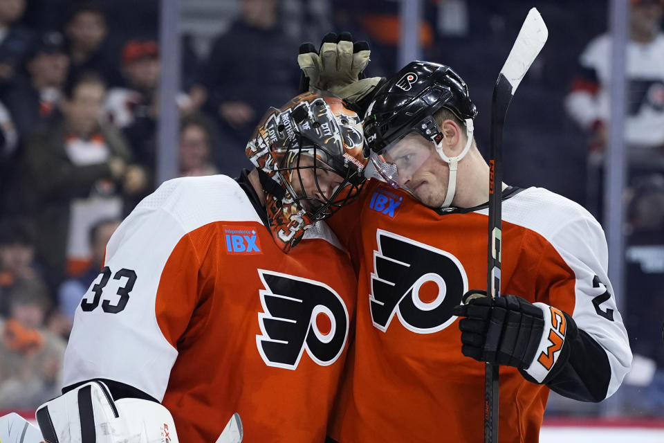 Philadelphia Flyers' Samuel Ersson, left, and Nick Seeler react after the Flyers won an NHL hockey game against the Tampa Bay Lightning, Tuesday, Feb. 27, 2024, in Philadelphia. (AP Photo/Matt Slocum)