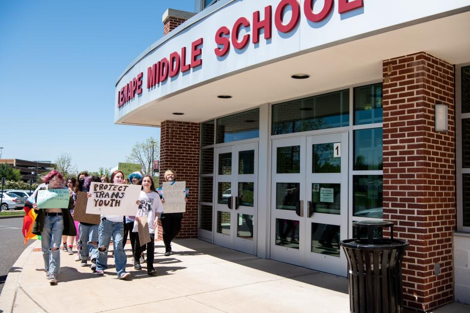 A small group of students march outside Lenape Middle School in Doylestown Borough, on Tuesday, May 10, 2022, protesting the recent suspension of Lenape Middle School teacher, Andrew Burgess.