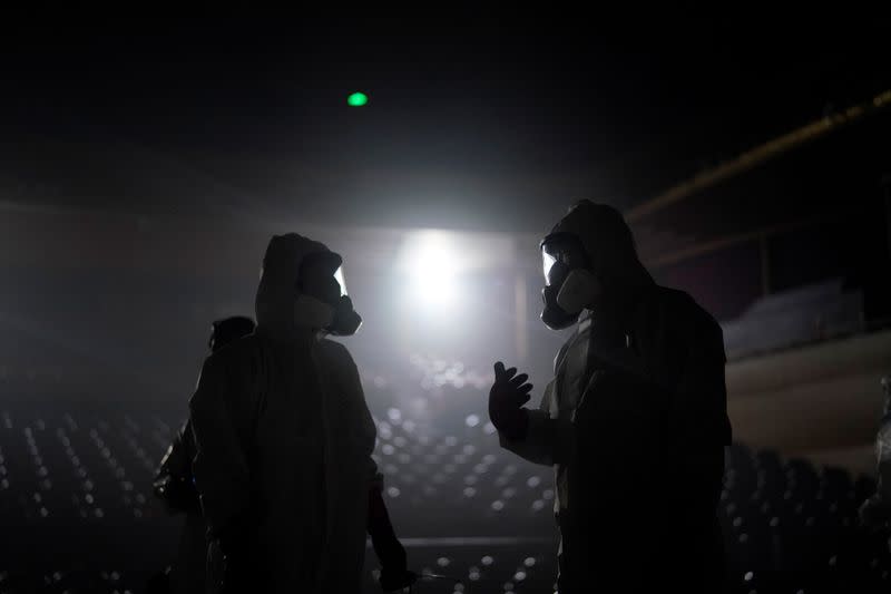 Volunteers from the Blue Sky Rescue team disinfect at the Qintai Grand Theatre in Wuhan