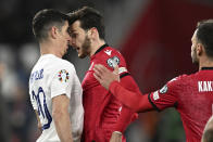 Georgia's Khvicha Kvaratskhelia, centre, argues with Greece's Petros Mantalos during the Euro 2024 qualifying play-off soccer match between Georgia and Greece at the Boris Paichadze National Stadium in Tbilisi, Georgia, Tuesday, March 26, 2024. (AP Photo/Tamuna Kulumbegashvili)