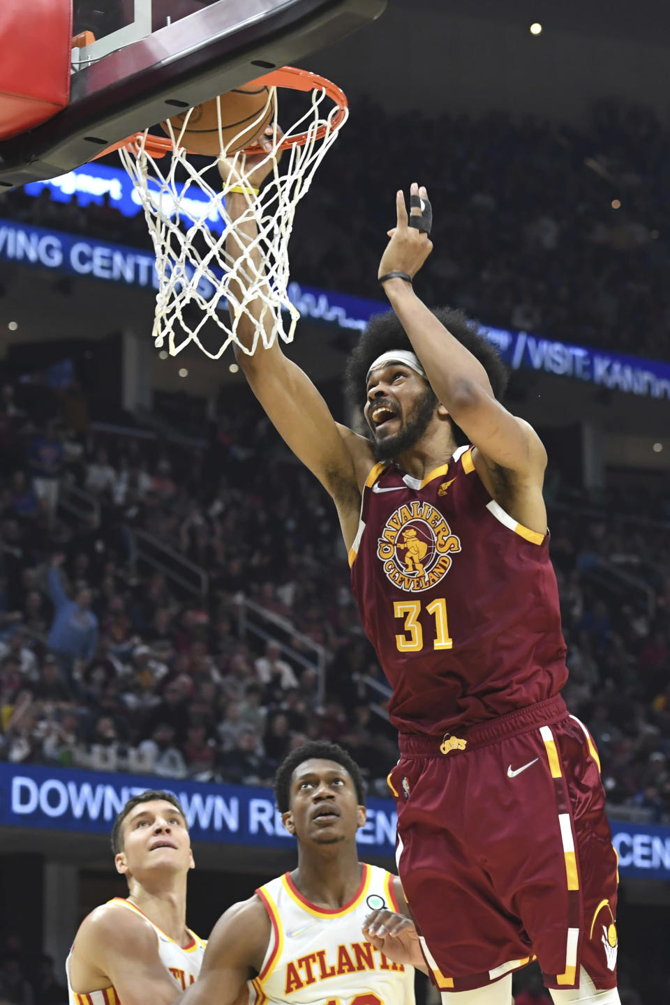 Cleveland Cavaliers' Jarrett Allen dunks during the first half of the team's NBA play-in basketball game against the Atlanta Hawks on Friday, April 15, 2022, in Cleveland. (AP Photo/Nick Cammett)