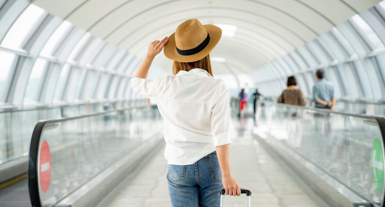 Woman walking at airport. (Getty Images)