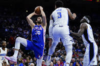 Philadelphia 76ers' Furkan Korkmaz, left, goes up for a shot against Orlando Magic's Chuma Okeke, center, and Mo Bamba during the first half of an NBA basketball game, Monday, Nov. 29, 2021, in Philadelphia. (AP Photo/Matt Slocum)