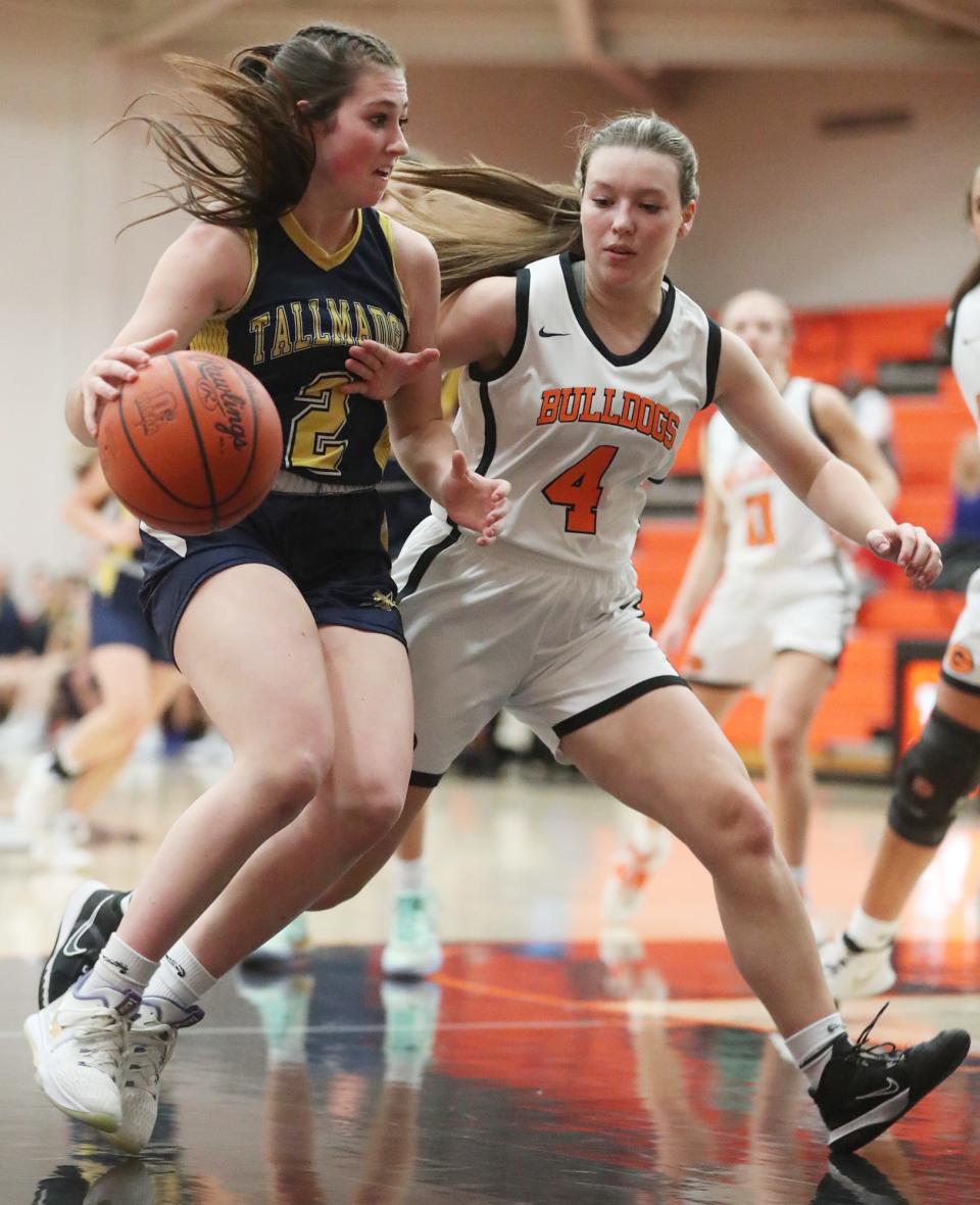 Tallmadge's Lexi Gray drives on Green's Madi Pukansky
in the first half of the game at Green High School. Green beat Tallmadge 72 to 28.