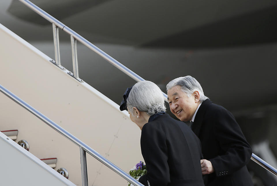 FILE - In this Jan. 26, 2016, file photo, Japan's Emperor Akihito smiles at Empress Michiko as they board their airplane to leave for the Philippines at Haneda International Airport in Tokyo. Japan’s Emperor Akihito has devoted his 30-year reign to making amends for a war fought in his father’s name, while adapting the 1,500-year-old monarchy’s traditions to draw the Imperial Family closer to the public. Akihito’s subtle public comments and insights from his classmates show him to be determined but also open to new ideas. He’s shown a keen awareness of his duties. (AP Photo/Eugene Hoshiko, File)