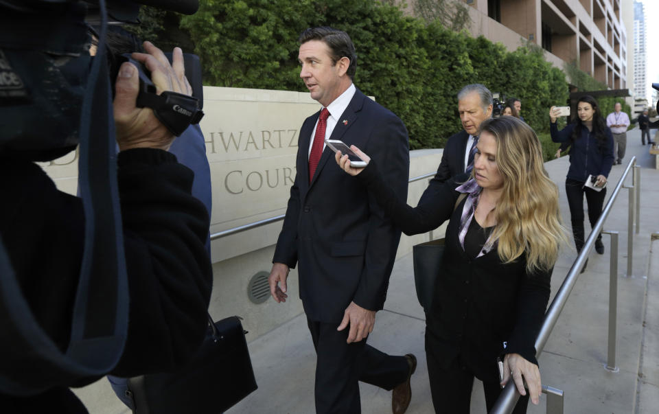 FILE - In this Dec. 3, 2018 file photo, Republican Rep. Duncan Hunter, center, leaves court in San Diego. The wife of U.S. Rep. Duncan Hunter pleaded guilty Thursday, June 13, 2019 to a single corruption count and agreed to testify against her husband at his trial on charges the couple spent more than $200,000 in campaign funds on trips, dinners, clothes and other personal expenses. (AP Photo/Gregory Bull,File)