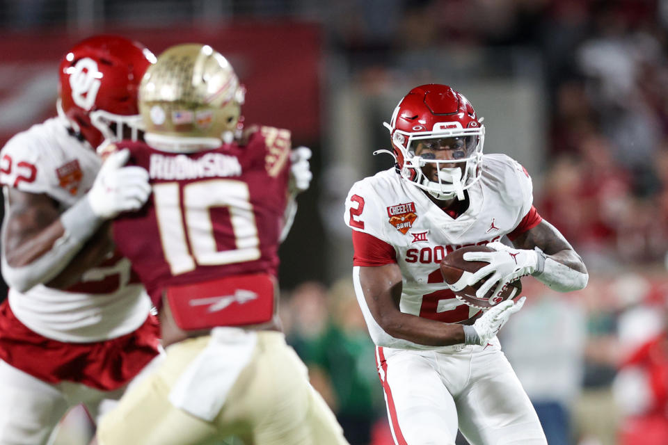 Dec 29, 2022; Orlando, Florida, USA; Oklahoma Sooners running back Jovantae Barnes (2) runs with the ball against the Florida State Seminoles in the first quarter during the 2022 Cheez-It Bowl at Camping World Stadium. Nathan Ray Seebeck-USA TODAY Sports