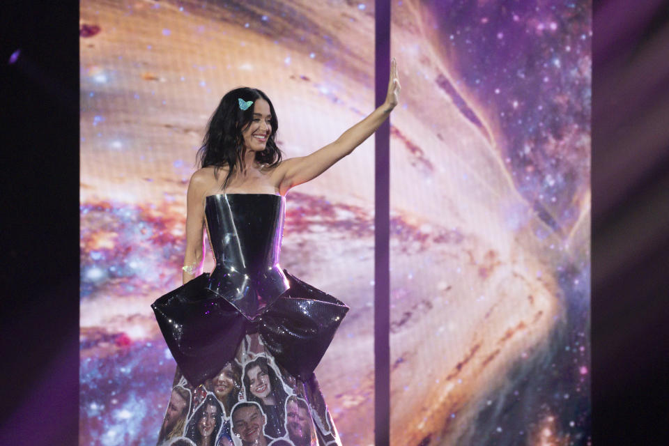 Katy Perry waves to the crowd during a performance.