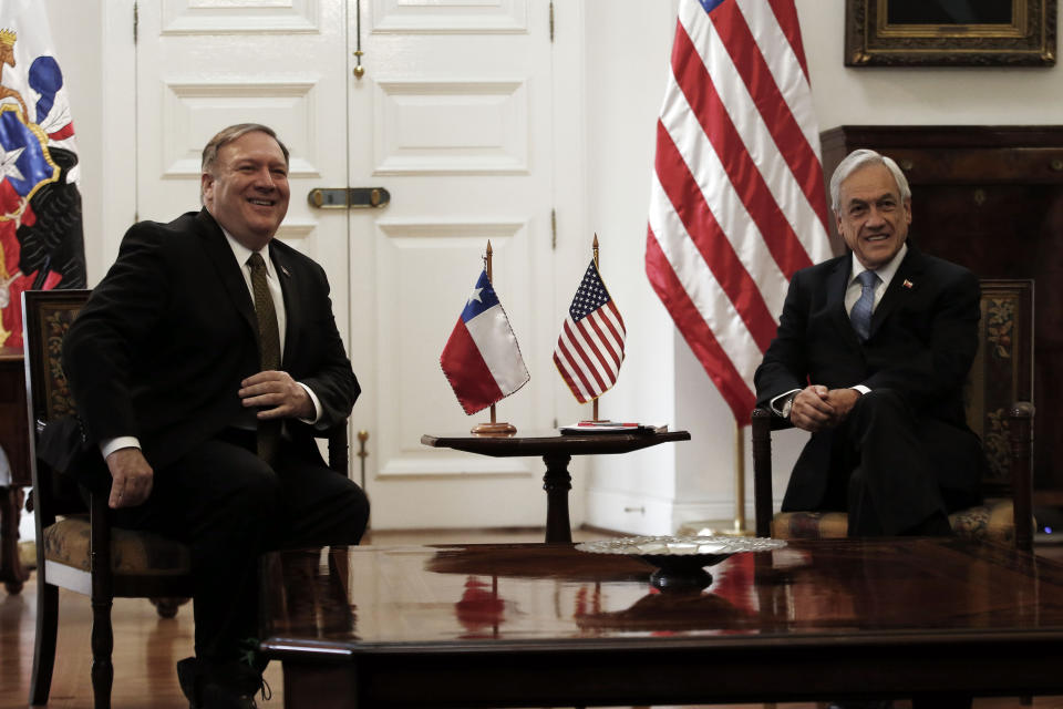 Chile's President Sebastian Piñera and U.S. Secretary of State Mike Pompeo, pose for photos before the start of their meeting at La Moneda Palace, in Santiago, Chile, Friday, April 12, 2019. Pompeo met Friday with Piñera to address, mainly, the vast crisis that afflicts Venezuela in the first round of a tour that includes Paraguay, Peru and Colombia. (AP Photo/Luis Hidalgo)