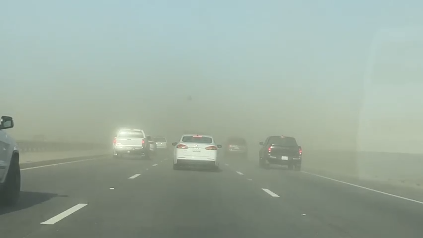 Strong winds blow sand and dirt across Interstate 10 in January.