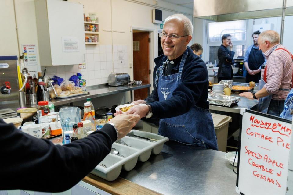 The Archbishop of Canterbury serves lunch at Catching Lives Open centre (Neil Turner/PA)