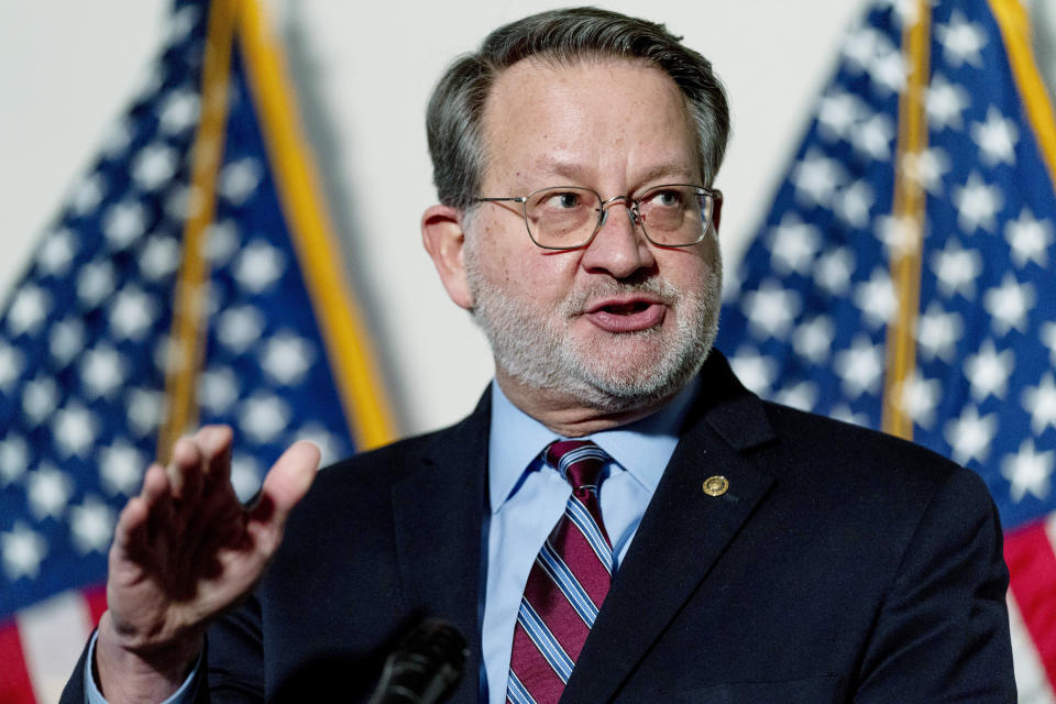 FILE - Sen. Gary Peters, D-Mich., speaks at a news conference on Capitol Hill in Washington, Feb. 8, 2022. Companies critical to U.S. national interests will have to report when they’re hacked or they pay ransomware. The new rules approved by Congress are part of a broader effort by the Biden administration and Congress to shore up the nation’s cyberdefenses after a series of high-profile digital espionage campaigns and disruptive ransomware attacks. (AP Photo/Andrew Harnik, File)