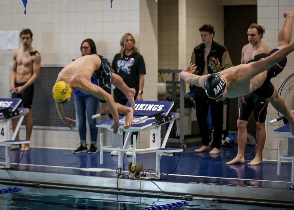 Cameron Tross of Erie Mason-Ida (left) and Tadas Zukovskis of Milan of Mila start the 50-yard freestyle at the Monroe County Championship Saturday. Tross won the event.