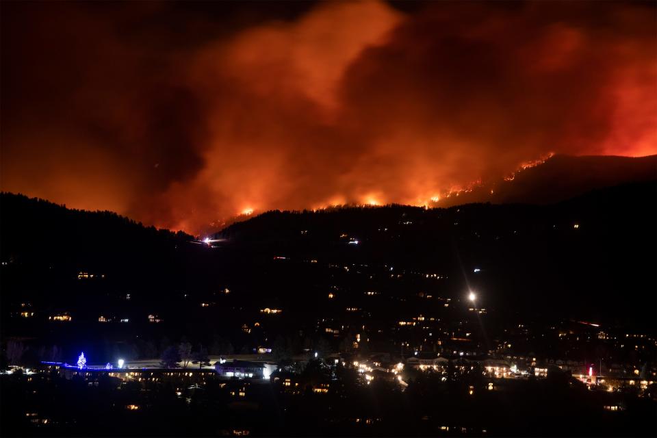 Flames from the Cameron Peak Fire, the largest wildfire in Colorado history, burn trees along a ridge outside Estes Park, Colo. on Friday, Oct. 16, 2020.