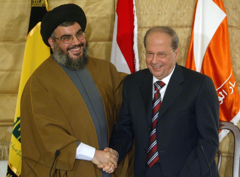 FILE PHOTO: Lebanon's Hezbollah leader Sheikh Hassan Nasrallah shakes hands with Christian leader Michel Aoun during news conference in Beirut