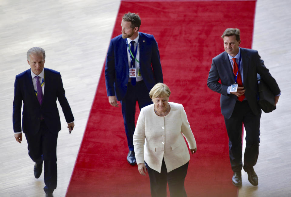 German Chancellor Angela Merkel walks on the red carpet as she arrives for an EU summit in Brussels, Thursday, June 20, 2019. European Union leaders are meeting for a two-day summit to begin the process of finalizing candidates for the bloc's top jobs. (AP Photo/Olivier Matthys)