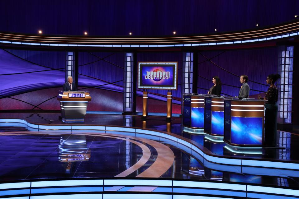 "Jeopardy!" has returned from its COVID-19 hiatus with an upgraded stage, with socially distanced contestants (right) who remain a safe distance away from host Alex Trebek.