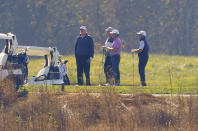 President Donald Trump, center standing, as he participates in a round of golf at the Trump National Golf Course on Saturday, Nov. 7, 2020, in Sterling, Va. (AP Photo/Patrick Semansky)