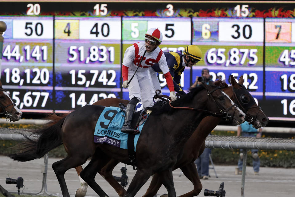 Irad Ortiz Jr. aboard Bricks and Mortar celebrates after winning the Breeders' Cup Turf horse race at Santa Anita Park, Saturday, Nov. 2, 2019, in Arcadia, Calif. (AP Photo/Gregory Bull)