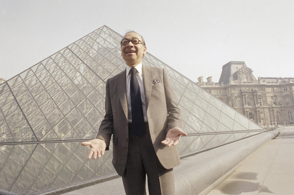 Chinese American architect I.M. Pei bursts out laughing while posing in front of the Louvre glass pyramid, prior to its inauguration on Mar. 29, 1989, in Paris. (Photo: AP)