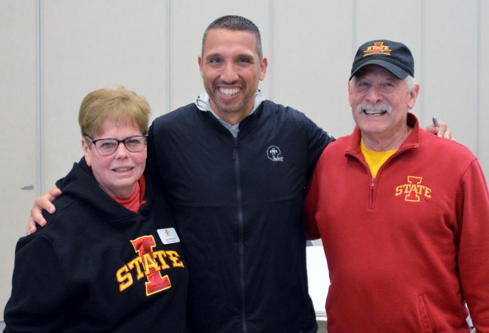 Lynn Marr Moore, the founder of Charlie's Angels, and her husband Reed Moore pose with Iowa State head football coach Matt Campbell.