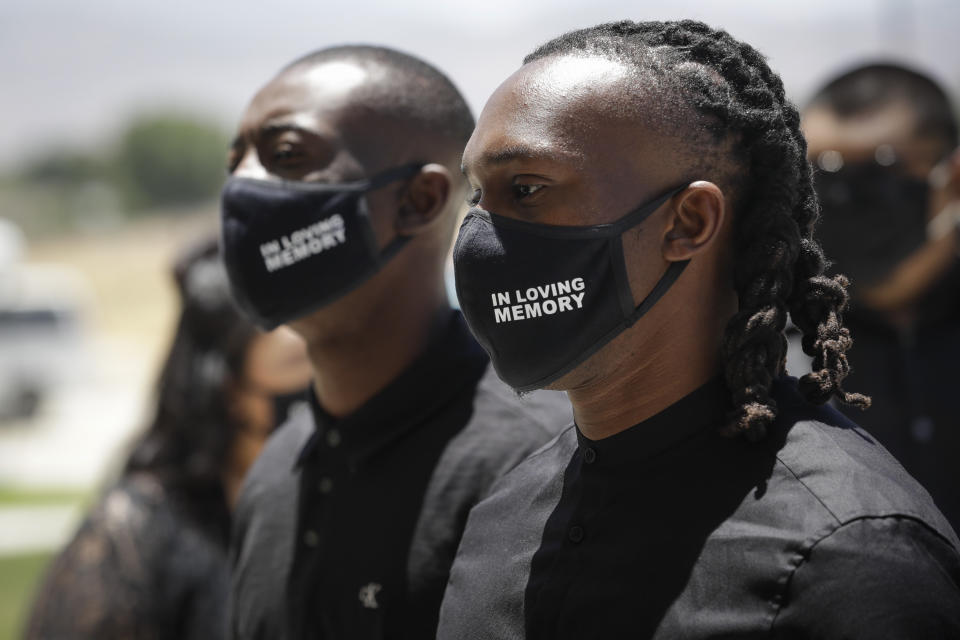 Mourners wears masks in honor of Robert Fuller during a funeral in his honor Tuesday, June 30, 2020, in Littlerock, Calif. Fuller, a 24-year-old Black man was found hanging from a tree in a park in a Southern California high desert city. Authorities initially said the death of Fuller appeared to be a suicide but protests led to further investigation, which continues. (AP Photo/Marcio Jose Sanchez)