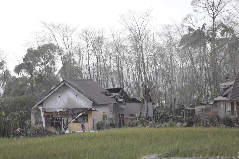 A man inspects the damage at his home in an area affected by the eruption of Mount Semeru in Lumajang, East Java, Indonesia, Sunday, Dec. 5, 2021. The highest volcano on Indonesia’s most densely populated island of Java spewed thick columns of ash, searing gas and lava down its slopes in a sudden eruption triggered by heavy rains on Saturday. (AP Photo/Trisnadi)