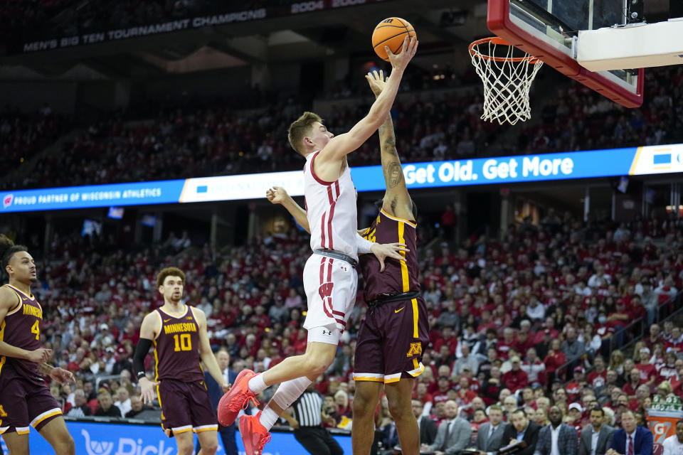 Wisconsin's Max Klesmit (11) against shoots against Minnesota's Ta'Lon Cooper, rightk,during the second half of an NCAA college basketball game Tuesday, Jan. 3, 2023, in Madison, Wis. (AP Photo/Andy Manis)