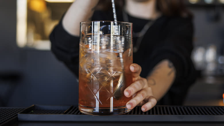 cocktail mixing glass being stirred