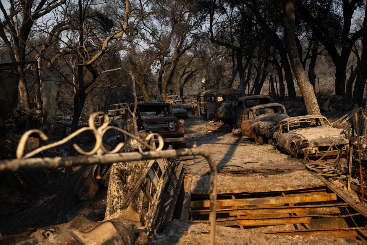 Vehicles burned in the Airport fire are seen in El Cariso Village near Lake Elsinore, Calif., on Wednesday.