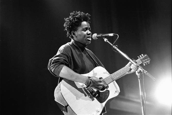 tracy playing guitar and singing on stage