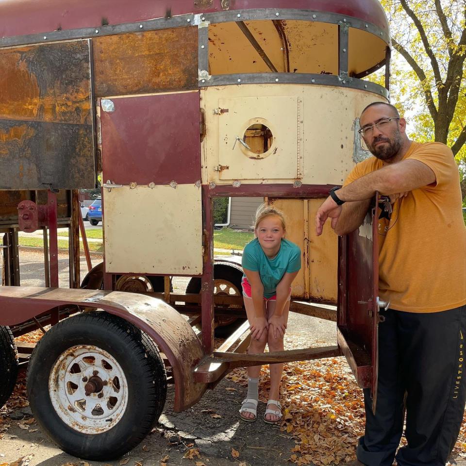 Chris Brockevelt and his daughter, Leighton, pose with the deconstructed horse trailer that they would convert into a waffle trailer.