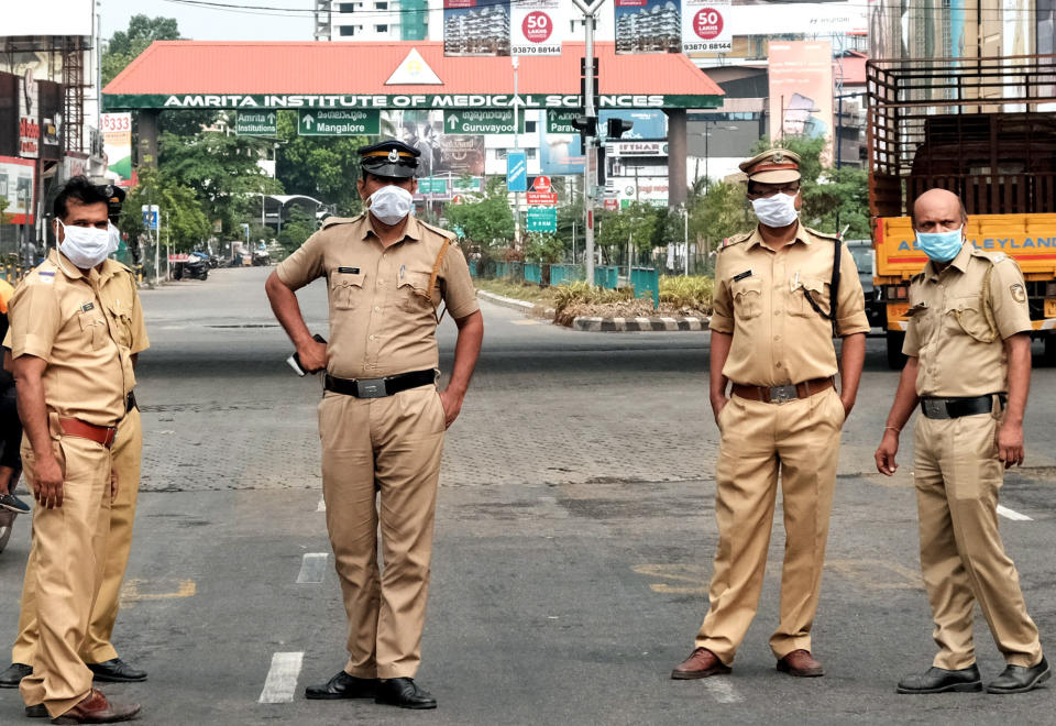 KOCHI ,INDIA, March 25, 2020. Police stand guard on a road in Kochi, India's southern state of Kerala, on March 25, 2020. The death toll from COVID-19 in India rose to 10 on Wednesday evening, the health ministry said. Meanwhile, the number of confirmed COVID-19 cases rose to 606. The Indian government Wednesday began a 21-day lockdown across the country in a bid to contain the spread of novel coronavirus. (Photo by Str/Xinhua via Getty) (Xinhua/Stringer via Getty Images)