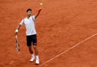 Tennis - French Open - Roland Garros - Novak Djokovic of Serbia v Roberto Bautista Agust - Paris, France - 31/05/16. Djokovic serves. REUTERS/Jacky Naegelen