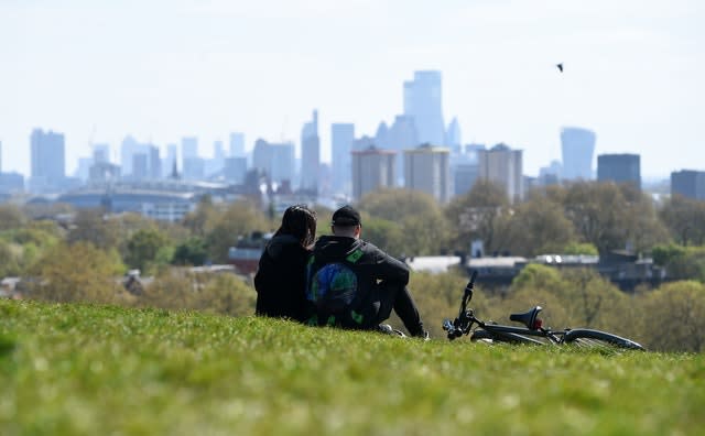 People sit on Primrose Hill, London (Kirsty O'Connor/PA)