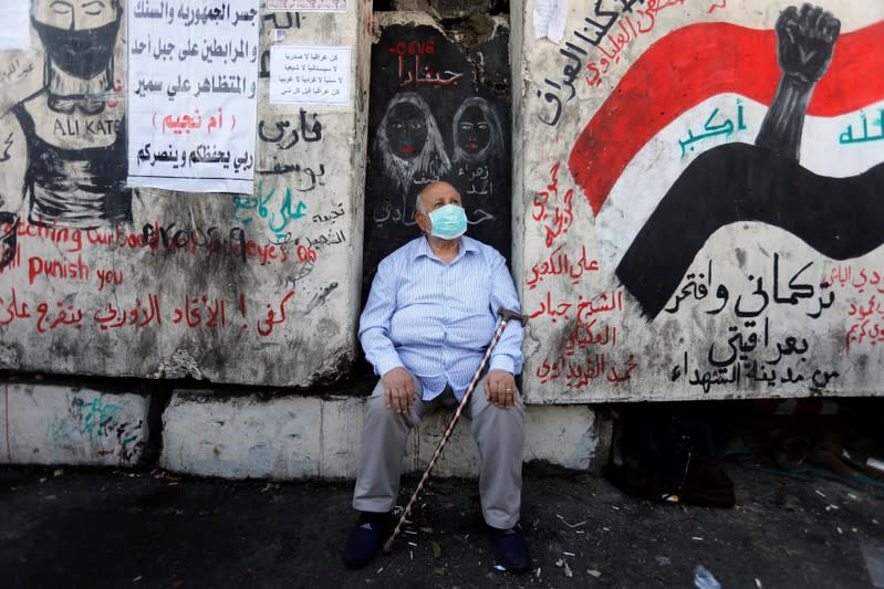 A man sits as he takes part in ongoing anti-government protests in Baghdad