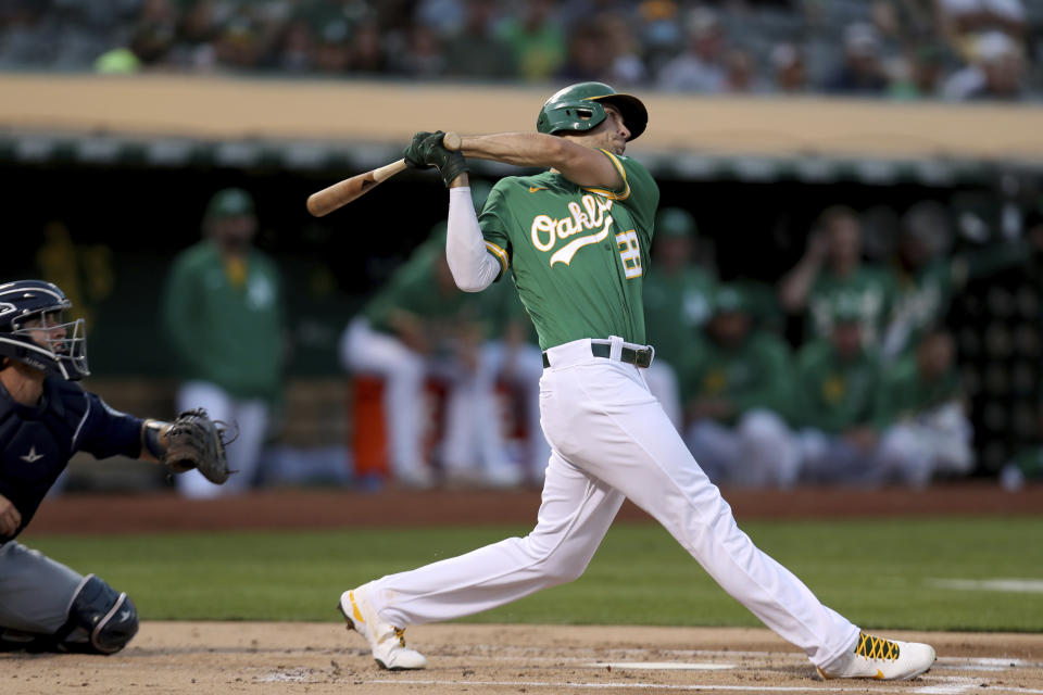 FILE - Oakland Athletics' Matt Olson, right, hits a solo home run in front of Seattle Mariners catcher Tom Murphy, left, during the first inning of a baseball game in Oakland, Calif., Tuesday, Sept. 21, 2021. Freddie Freeman's tenure with the Atlanta Braves appears to be over after the World Series champions acquired All-Star first baseman Matt Olson from the Oakland Athletics on Monday, March 14, 2022. (AP Photo/Jed Jacobsohn, File)