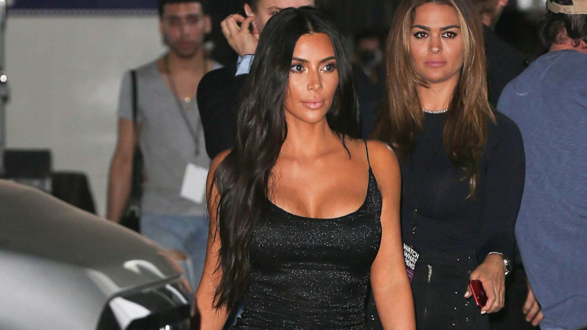 kim kardashian stuns in a form-fitting yellow dress as she arrives