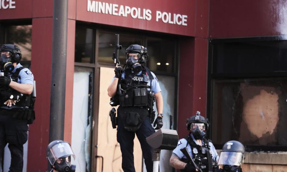 Police in riot gear outside the third precinct during protests over the death of George Floyd in Minneapolis, Minnesota, on 27 May.