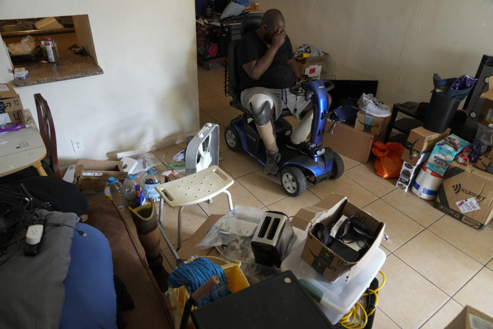 Freddie Davis, who lost a leg to diabetes, suffers from congestive heart failure, and is recovering from multiple wounds on his other leg and foot, reacts as he organizes his remaining belongings to be moved to a storage unit after receiving a final eviction notice, Wednesday, Sept. 29, 2021, in Miami. Davis' eviction in September was a little over a month after a federal eviction moratorium ended. (AP Photo/Rebecca Blackwell)