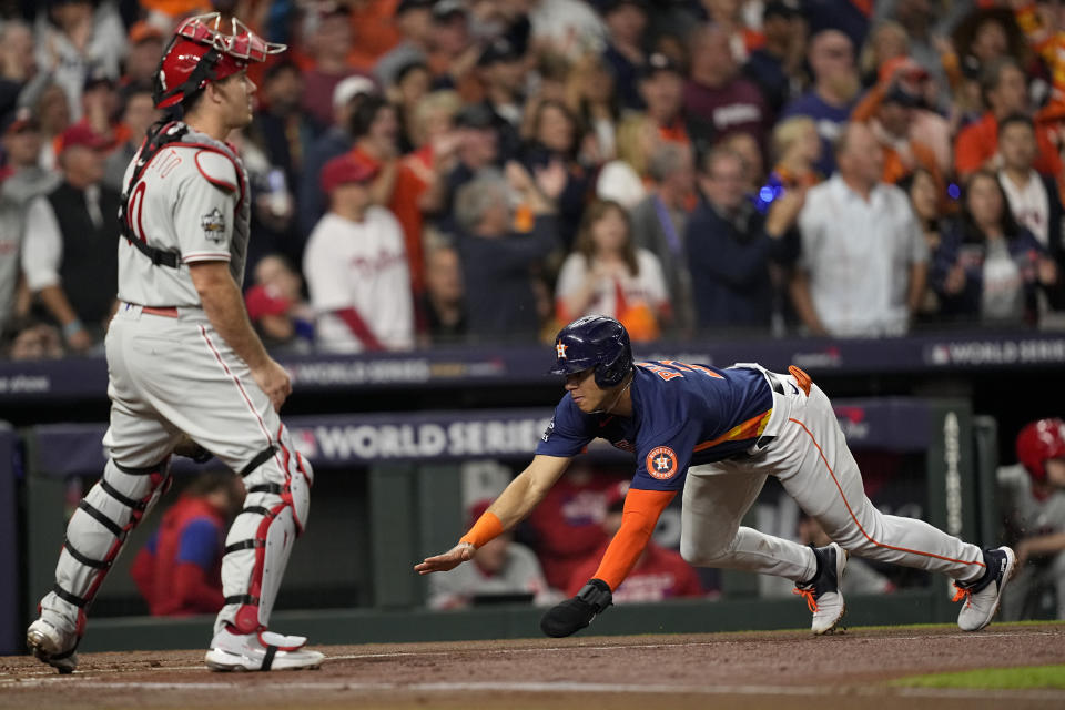 Houston Astros' Jeremy Pena scores on an RBI double hit by Houston Astros' Yordan Alvarez during the first inning in Game 2 of baseball's World Series between the Houston Astros and the Philadelphia Phillies on Saturday, Oct. 29, 2022, in Houston. (AP Photo/David J. Phillip)