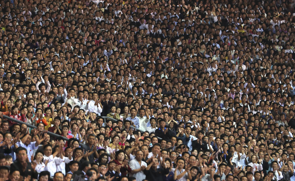 FILE - In this Sept. 19, 2018, file photo, North Koreans welcome South Korean President Moon Jae-in and North Korean leader Kim Jong Un during the mass games performance of "The Glorious Country" at May Day Stadium in Pyongyang, North Korea. On Wednesday evening, Sept. 19, South Korea's President Moon Jae-in and North Korean leader Kim Jong Un went to the 150,000-seat May Day Stadium to watch a “Glorious Country” mass performance. The performers moved in unison to display handshakes between Kim and Moon and an undivided Korean Peninsula. (Pyongyang Press Corps Pool via AP)