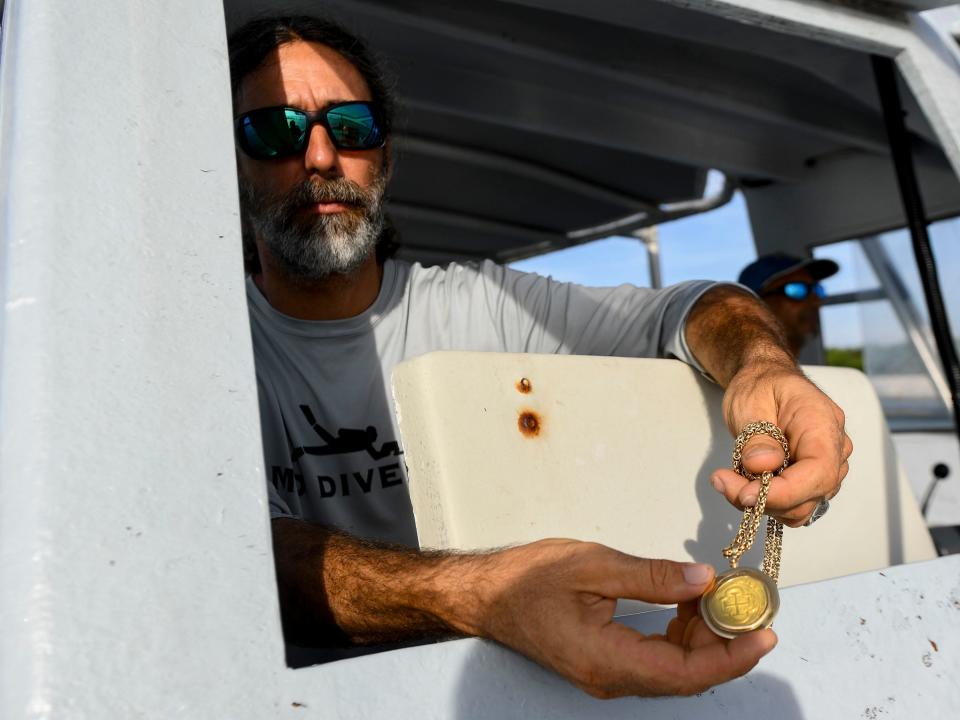 Michael Perna, a professional historic shipwreck salvor, holds a gold doubloon he found a few hundred yards offshore of Treasure Shores Beach Park in Indian River County. “It just takes guys like us to really go out there and look for it, because it’s a needle in a haystack," he said. "It takes a lot of diligence, a lot of persistence and maybe just a little bit of craziness to keep going.”