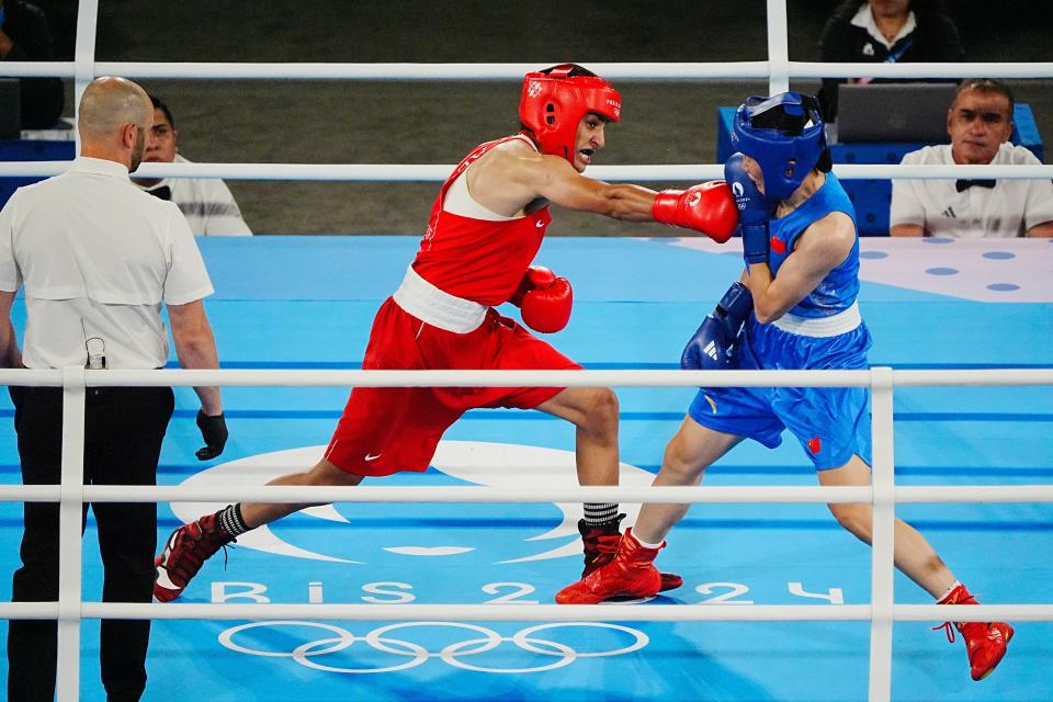 Aug 9, 2024; Paris, France; Imane Khelif (ALG) strikes Yang Liu (CHN) in a women’s 66kg gold medal bout during the Paris 2024 Olympic Summer Games at Stade Roland Garros. Mandatory Credit: Andrew P. Scott-USA TODAY Sports