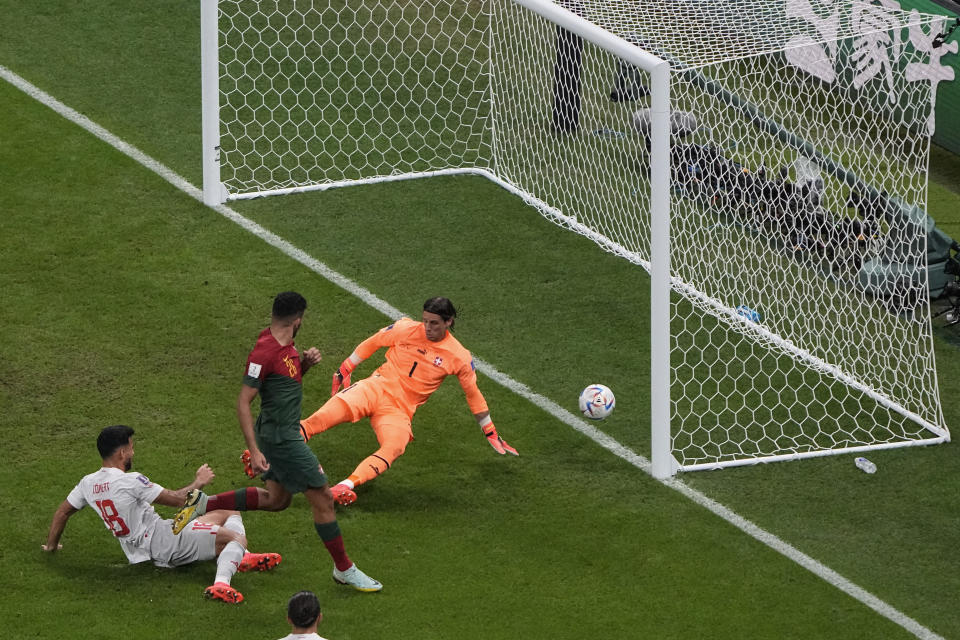 Portugal's Goncalo Ramos, second left, scores his side's third goal in front pf Switzerland's goalkeeper Yann Sommer during the World Cup round of 16 soccer match between Portugal and Switzerland, at the Lusail Stadium in Lusail, Qatar, on Tuesday, Dec. 6, 2022. (AP Photo/Ariel Schalit)