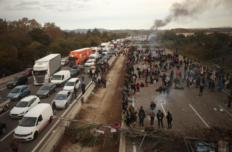 FILE - Catalan pro-independence demonstrators spend the night blocking a major highway near Girona, Spain, Wednesday, Nov. 13, 2019. Thousands of ordinary citizens got into legal trouble for their parts in Catalonia’s illegal independence bid that brought Spain to the brink of rupture six years ago. Now they are hoping to be saved. Spain’s acting prime minister, Pedro Sánchez, is negotiating with Catalan separatist parties on the possibility of issuing a sweeping amnesty for the separatists in exchange for their helping him form a new national government in Madrid. (AP Photo/Joan Mateu, File)