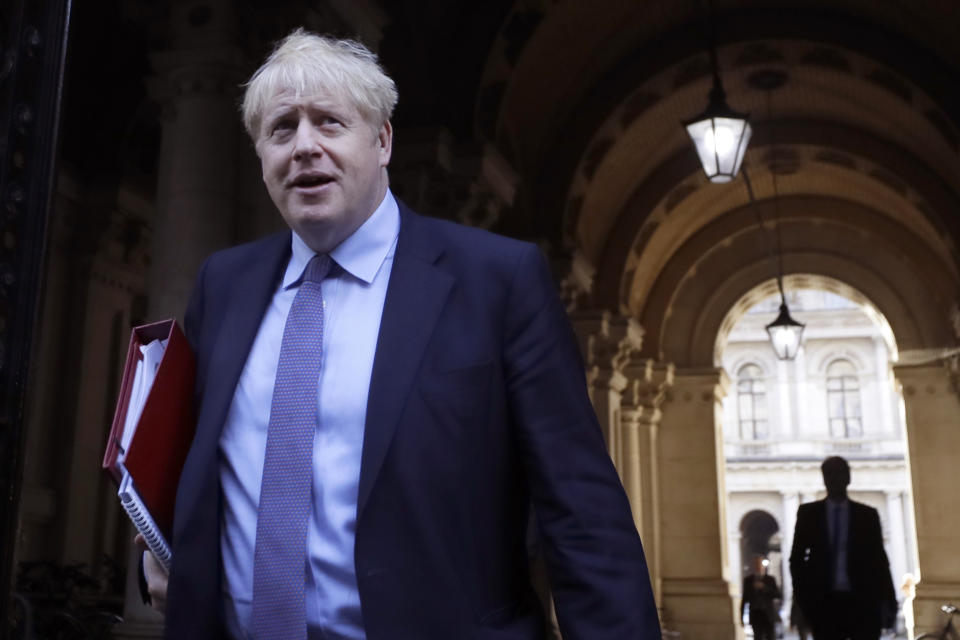 Britain's Prime Minister Boris Johnson returns to Downing Street after attending a Cabinet meeting in London, Tuesday, Oct. 20, 2020. (AP Photo/Kirsty Wigglesworth)