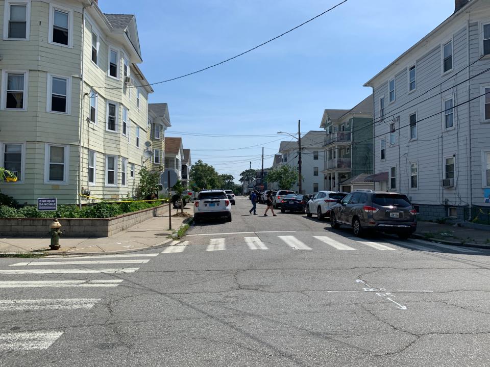 On Sunday, July 24, police are stationed outside the site of a fatal shooting that happened Saturday night on Wallace Street in Providence.