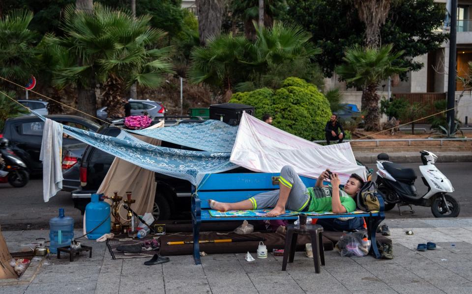 People displaced by Israeli air strikes on Beirut have created makeshift shelters on the Corniche in Beirut